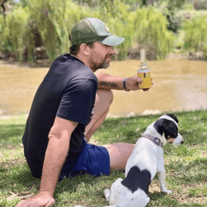 Man using boutique beer gauge with dog