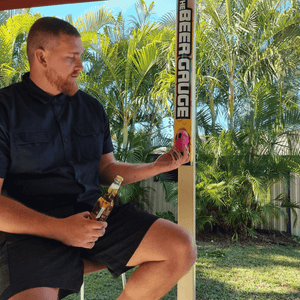 Man getting beer gauge out of stubby holder holder