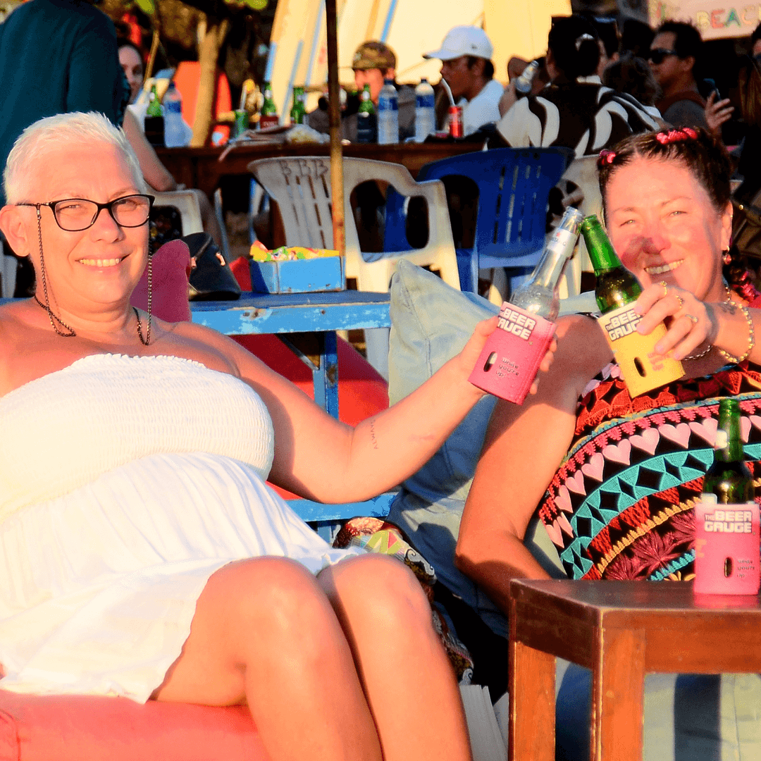 2 girls on legian beach with boutique beer gauges