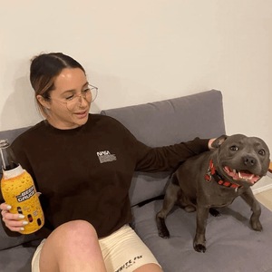 Lady and dog with long neck stubby holder Australia