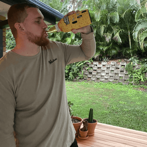 Man drinking long neck stubby holder 700-750ml